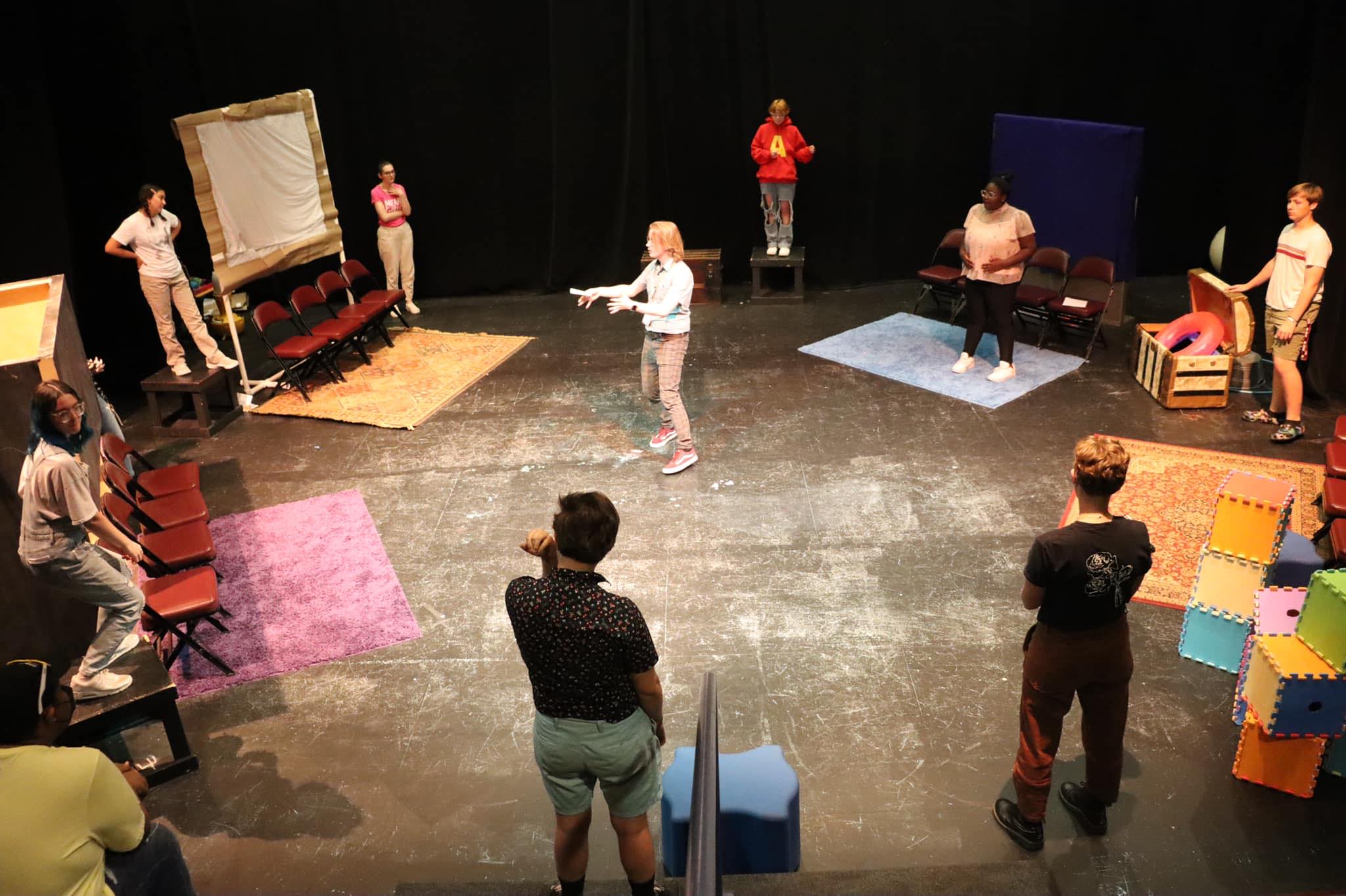 Jay leading a summer camp warm up with students in a circle